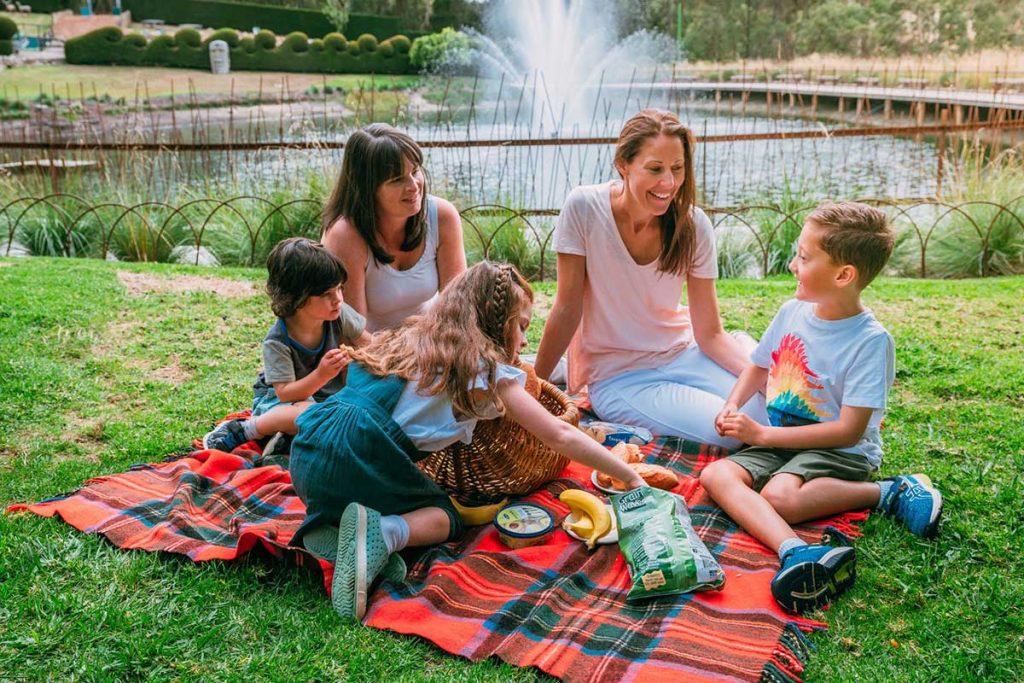 Mums and kids having a picnic at Enchanted Adventure