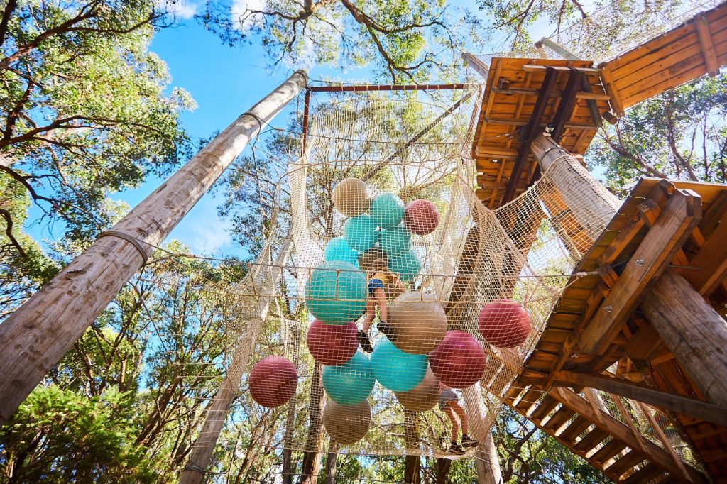 Photo looking up from the ground at the giant net ballpits on the Sky Scramble at Enchanted Adventure