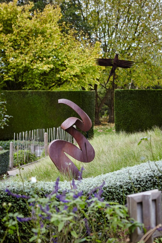 Close up photo of two sculptures in one of the themed formal gardens at Enchanted Adventure